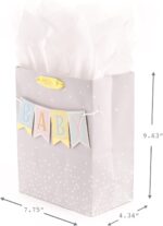 Hallmark medium baby gift bag with a "BABY" banner, foil accents, and a yellow ribbon handle, displayed with white tissue pap