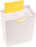 Hallmark medium baby gift bag with a "BABY" banner, foil accents, and a yellow ribbon handle, displayed with white tissue pap
