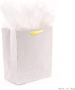 Hallmark medium baby gift bag with a "BABY" banner, foil accents, and a yellow ribbon handle, displayed with white tissue pap