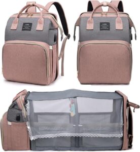 Pink houscly diaper bag backpack with changing station, open to show compartments and accessories.