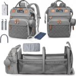 Grey Inclusive LittleOnes diaper bag backpack with a changing station unfolded, showing baby essentials and a pacifier case.
