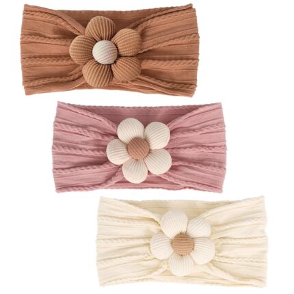 Three soft nylon baby headbands with flower embellishments in yellow, pink, and brown colors, suitable for infants.
