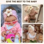 Three soft nylon baby headbands with flower embellishments in yellow, pink, and brown colors, suitable for infants.