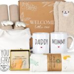 A 9-piece khaki new mom and dad gift set with mugs, baby onesie, swaddle blanket, socks, and affirmation cards.