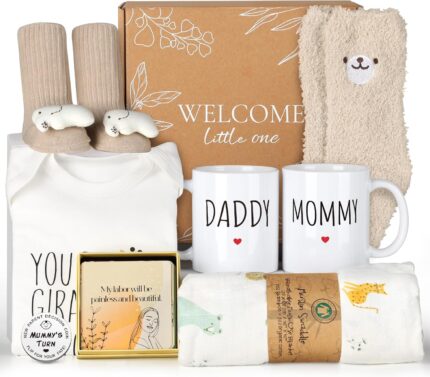 A 9-piece khaki new mom and dad gift set with mugs, baby onesie, swaddle blanket, socks, and affirmation cards.