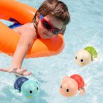 Three colorful TOHIBEE wind-up turtle bath toys, blue, green, and red, floating in water, designed for toddlers.