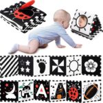 A black and white high contrast baby soft book with a mirror, featuring various patterns like stars and floral designs.