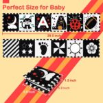 A black and white high contrast baby soft book with a mirror, featuring various patterns like stars and floral designs.