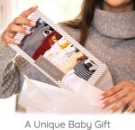 Seven pairs of ZIRI & ZANE baby socks in various multi-color, animal print, letter print, and striped patterns.